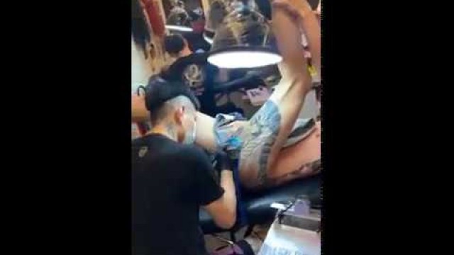 'Young fit naked Asian man screaming during tattoo session on his bottom 4'