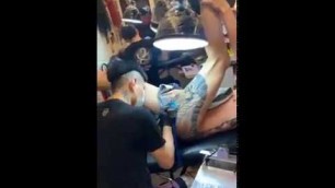 'Young fit naked Asian man screaming during tattoo session on his bottom 4'